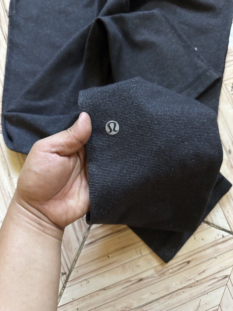 Lululemon Black Ribbed Drawstring Athletic Pants size 4 (Category: Joggers) located in Angeles City. Submitted by alejeong27 (Listing ID 1468337110, Image 3). Description: - Brand: Lululemon - Color: Dark charcoal black - Size: 4 (verified by size dot in pocket) - Material: Ribbed textured fabric - Features: Adjustable drawstring waistband, two front pockets, straight leg cut - Details: Classic silver omega logo near the lower leg cuff - Conditio