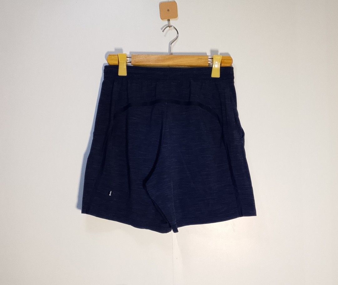 Lululemon Blue Heathered Athletic Shorts Size M (Category: Shorts) located in Manila. Submitted by moisky18 (Listing ID 1468455220, Image 2). Description: - Brand: Lululemon - Size: M (printed waistband tag) - Color/Pattern: Dark Blue Heathered Texture - Features: Secure side zip pocket for keys/cards, lightweight stretch fabric - Branding: Iconic Lululemon logo near bottom hem and back - Condition: Excellent - Ideal for: Running, workouts, or ca