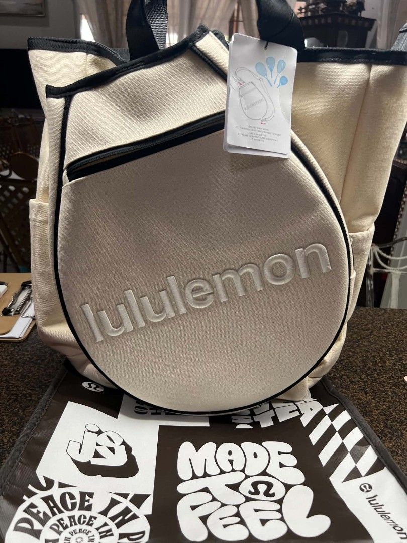 Lululemon Canvas Racquet Backpack Bag Off White (Category: Backpacks) located in Manila. Submitted by myrabundoc63934 (Listing ID 1468372188, Image 1). Description: - Brand new with original store tags attached - Authentic Lululemon off-white heavy-duty cotton canvas backpack - Dedicated circular front pocket designed specifically for a racquet, featuring a hanging tag instruction graphic - Stylish black trim details with convenient top grab hand
