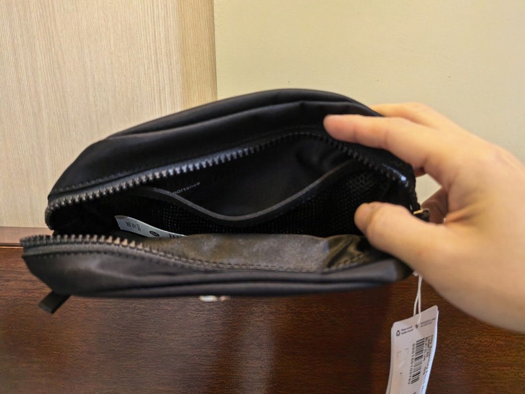 Lululemon City Essentials Pouch Mini Black (Category: Purses & Pouches) located in Manila. Submitted by maifabfinds (Listing ID 1468459978, Image 2). Description: - Brand new with original store tags attached - Color: Classic Black - Durable fabric material built to last - Secure zip closure to keep items safe - Convenient front slip pocket for quick access - Interior mesh compartment for organizing small essentials - Compact and versatile Lulule