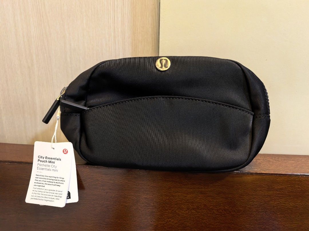 Lululemon City Essentials Pouch Mini Black (Category: Purses & Pouches) located in Manila. Submitted by maifabfinds (Listing ID 1468459978, Image 1). Description: - Brand new with original store tags attached - Color: Classic Black - Durable fabric material built to last - Secure zip closure to keep items safe - Convenient front slip pocket for quick access - Interior mesh compartment for organizing small essentials - Compact and versatile Lulule