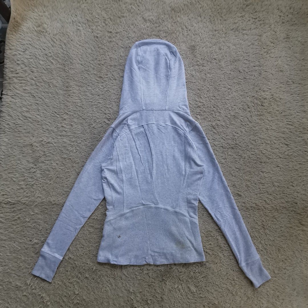 Lululemon Define Jacket Grey Size 6 (Category: Coats, Jackets and Outerwear) located in Davao. Submitted by dmp1993 (Listing ID 1468455379, Image 2). Description: Grey Lululemon zip-up jacket in size 6. Full front zipper, high neckline, and a hood with drawstrings. Long sleeves with thumbholes. Two zippered hand pockets on the front. Ribbed fabric panels along the sides and back hem. Interior white lining..
