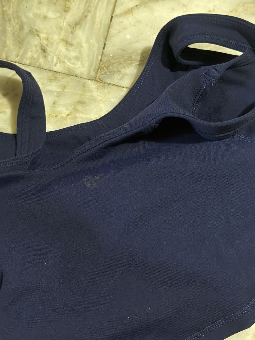 lululemon navy blue athletic tank top (Category: Sleeveless) located in Pozorrubio. Submitted by christajoi79316 (Listing ID 1468345534, Image 3). Description: - Brand: Lululemon - Color: Dark Navy Blue - Design: Scoop neckline with thick straps and subtle logo at back hem - Support: Built-in bra lining with pockets for removable cups - Material: Soft, stretchy, and breathable workout fabric - Ideal for: Gym workouts, yoga sessions, and casual da