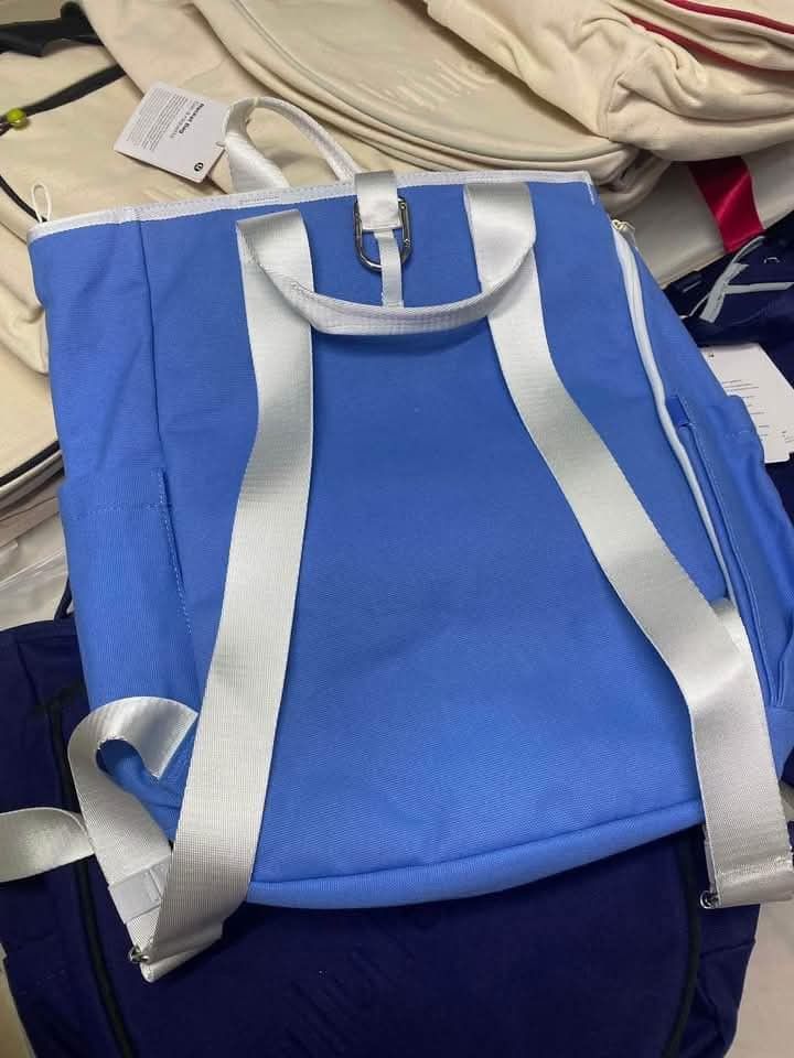 Lululemon Racket Bag Canvas Backpack Tennis Bag (Category: Backpacks) located in Del Monte. Submitted by balanijoan70708 (Listing ID 1468343424, Image 3). Description: - Brand new Lululemon racket bag in original protective packaging - Available in multiple solid colors: Blue, White, and Dark Blue - Dimensions: Approx. 31cm x 42cm - Material: Sturdy, durable canvas - Features a matching detachable front racket pouch with zipper closure - Spacious