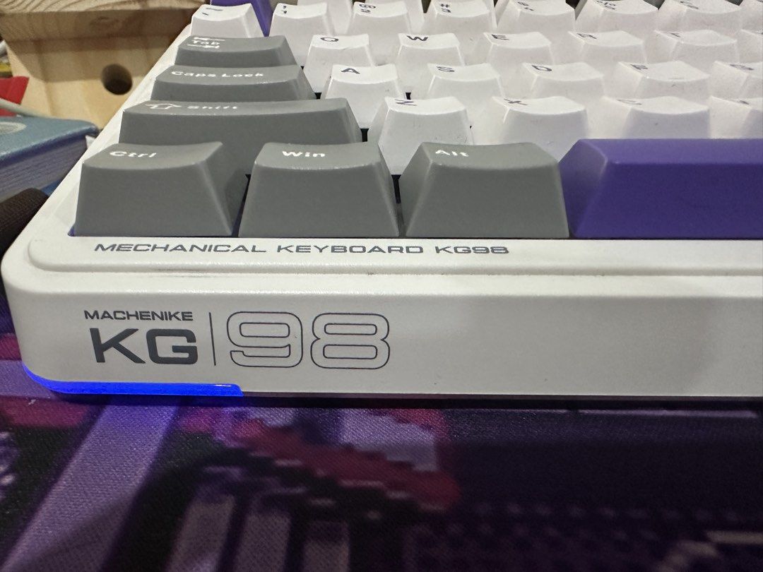 Machenike KG98 Tri-Mode Mechanical Keyboard White Purple (Category: Computer Keyboard) located in Kawit. Submitted by wevibevintage (Listing ID 1468434485, Image 3). Description: Machenike KG98 tri-mode mechanical keyboard in white and purple colorway. Purple gold switches, massive 8000mAh battery, polycarbonate plate, and 5-layer noise-reducing foam. Full-size layout with numeric keypad and arrow keys. Wireless connectivity options via Bluetooth