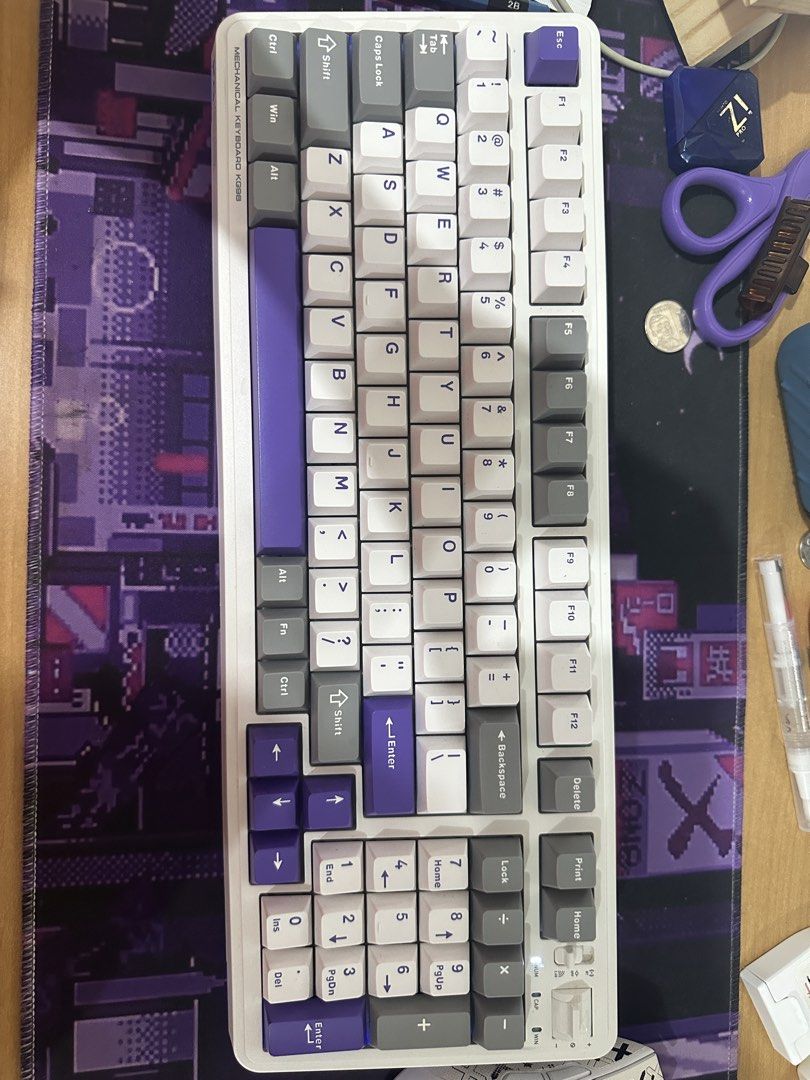 Machenike KG98 Tri-Mode Mechanical Keyboard White Purple (Category: Computer Keyboard) located in Kawit. Submitted by wevibevintage (Listing ID 1468434485, Image 2). Description: Machenike KG98 tri-mode mechanical keyboard in white and purple colorway. Purple gold switches, massive 8000mAh battery, polycarbonate plate, and 5-layer noise-reducing foam. Full-size layout with numeric keypad and arrow keys. Wireless connectivity options via Bluetooth