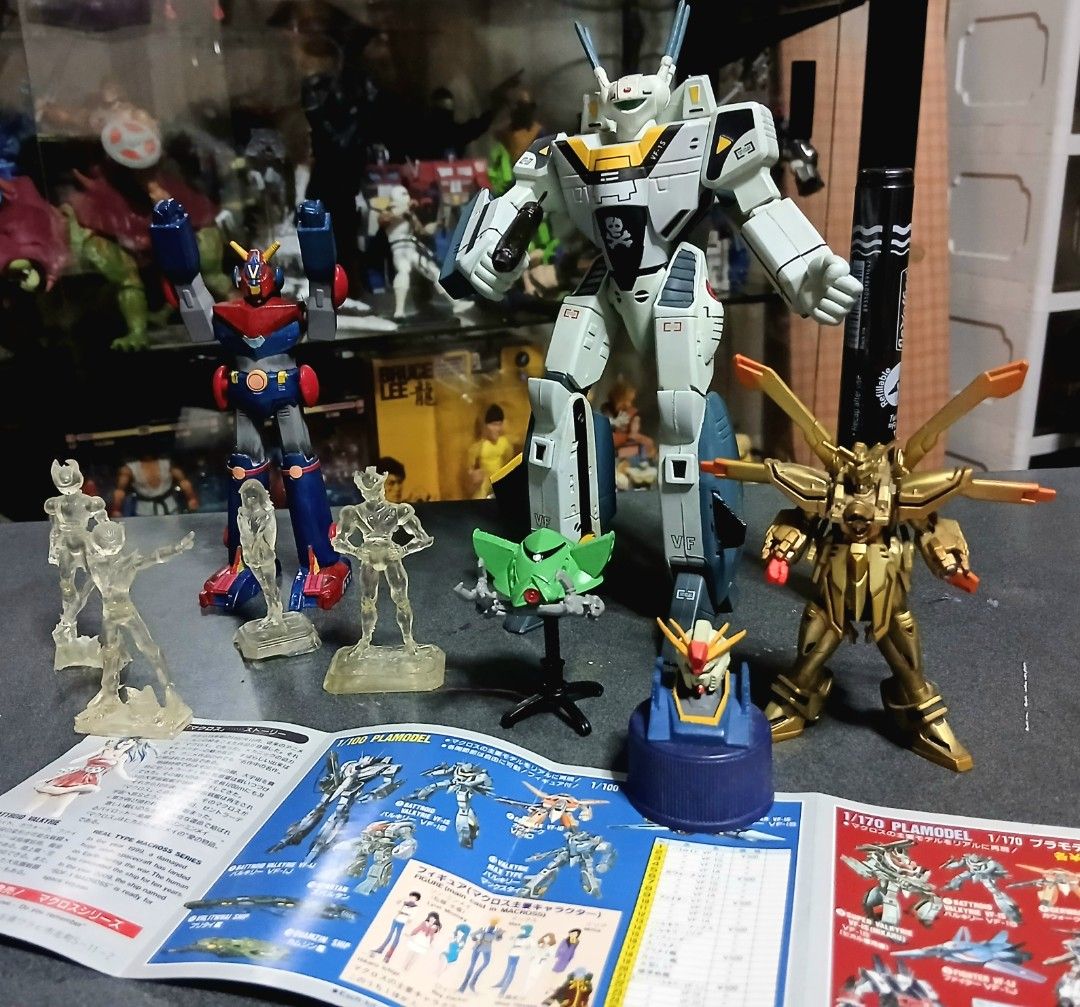 Macross VF-1S and vintage anime robot model bundle (Category: Gundam & Model Kits) located in Quezon City. Submitted by mrs.maria (Listing ID 1468471415, Image 1). Description: - Complete retro mecha and anime figure lot - Includes large Macross VF-1S Valkyrie model with gun, red and blue robot, gold mechanical figure, and green spaceship on a stand - Comes with 4 clear resin character statues and manual booklet -Open po for trade G.I Joe Classif