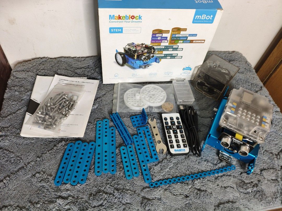 Makeblock mBot Educational Robot Kit STEM (Category: Lego & Building Sets) located in Lubao. Submitted by aczcollectibles (Listing ID 1468353445, Image 1). Description: Makeblock mBot educational robot kit for learning STEM concepts. Blue metal chassis, ultrasonic sensor, IR remote control, gears, wheels, metal plates, screws, and cables included. Original box and instruction manuals present. Great set for hands-on coding and robotics projects. A