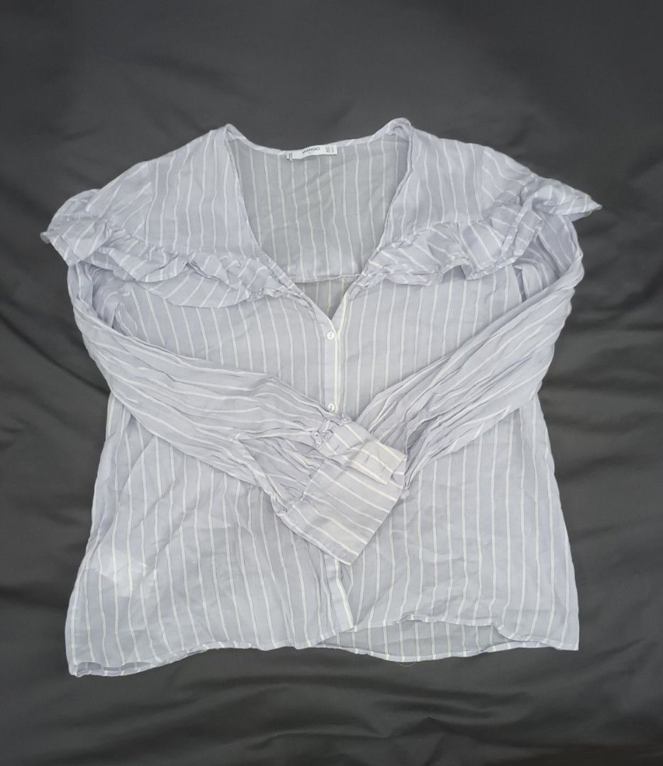 Mango Blue Striped Ruffle Blouse Size M (Category: Blouses) located in Mandaluyong City. Submitted by bestill4610 (Listing ID 1468406175, Image 2). Description: Mango Longsleeves Soft light cotton Ruffle accent V-neckline, botton-down Never used. just needs washing W 21" x L 24".