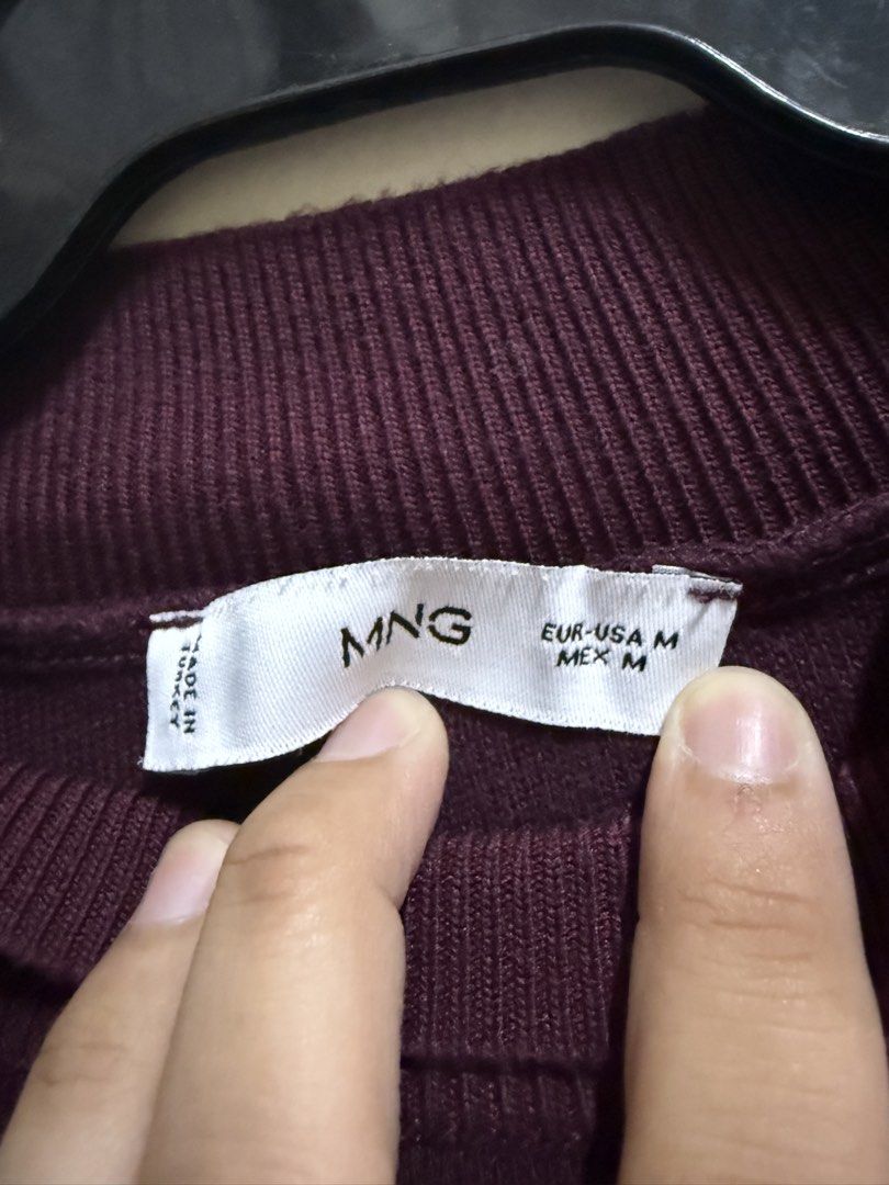 Mango Burgundy Knit Short Sleeve Top Medium (Category: Sleeveless) located in Quezon City. Submitted by mikaela_0 (Listing ID 1468354904, Image 3). Description: - Brand: Mango - Style: Sleeveless mock neck knit top - Color: Dark purple / Burgundy - Size: Medium - Origin: Made in Turkey - Fabric: Soft knit - Condition: Good/Worn with care - Features: Ribbed collar and hem, versatile basic for layering or everyday wear.