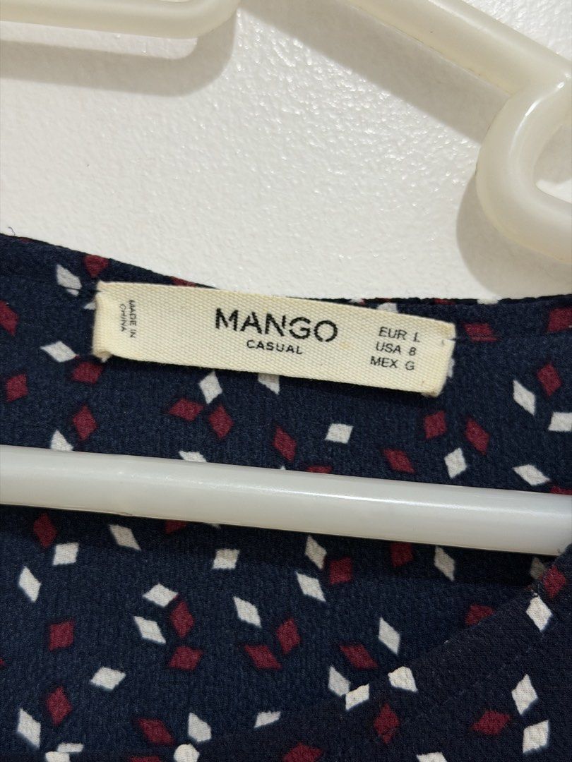 Mango Navy Blue Cold Shoulder Dress (Category: Dresses) located in Malolos. Submitted by eadiana (Listing ID 1468487511, Image 3). Description: - Brand: Mango - Color: Navy blue with tiny white and maroon diamond pattern - Style: Cold shoulder cutouts, draped short sleeves, and layered bodice overlay - Closure: Keyhole button closure at the back neckline - Size: EUR L, USA 8, MEX G - Fabric: Lightweight and comfortable, perfect for casual outings