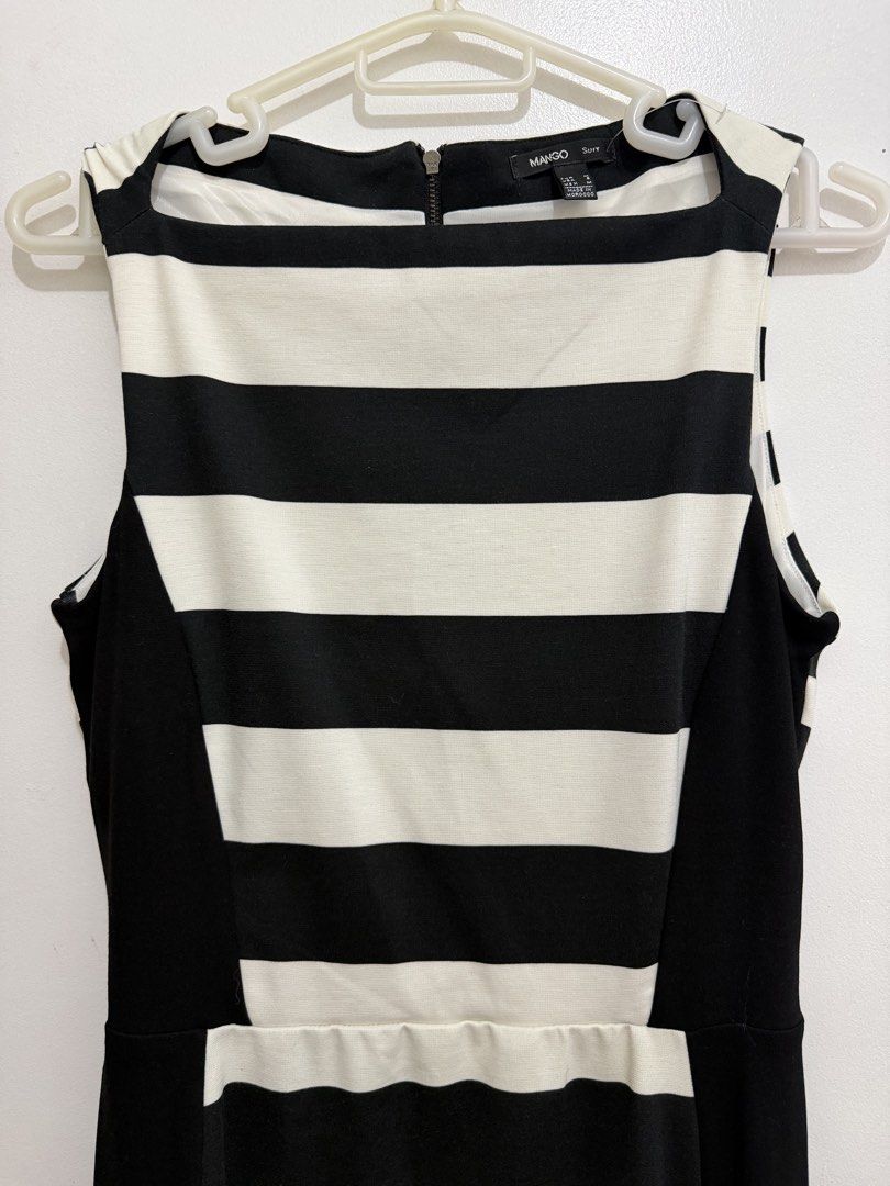 Mango Suit Black and White Striped Dress (Category: Dresses) located in Malolos. Submitted by eadiana (Listing ID 1468487330, Image 2). Description: - Brand: Mango Suit - Pattern: Black and white stripes with slimming solid black side panels - Cut: Sleeveless with a chic boat neckline - Details: Full-length exposed zipper down the back, fully lined interior - Size: M EUR/MEX (Equivalent to S USA) - Origin: Made in Morocco - Condition: Excellent, 
