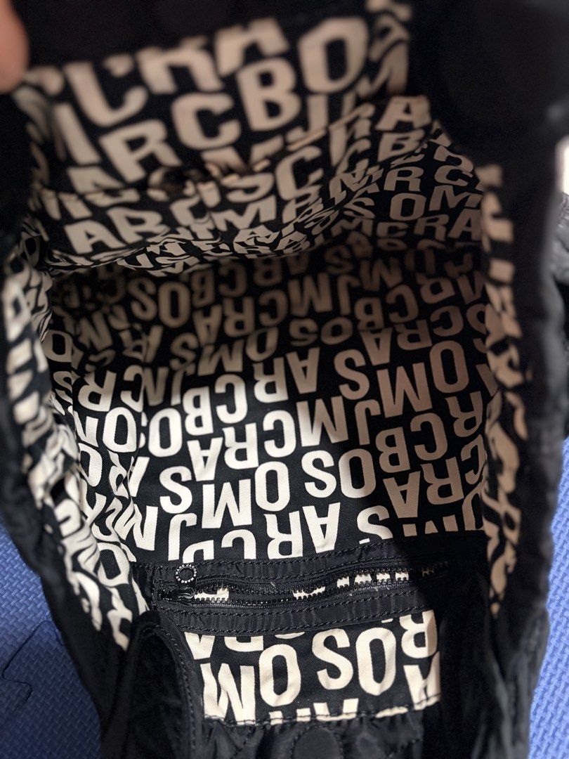 Marc by Marc Jacobs Quilted Nylon Tote Bag (Category: Tote Bags) located in Quezon City. Submitted by pattycloset08 (Listing ID 1468425884, Image 2). Description: - Brand: Marc by Marc Jacobs - Style: Quilted nylon tote bag with iconic standard supply metal patch - Material: 100% durable black nylon - Straps: Dual handle straps with stylish knotted accents - Interior: Signature black and white monogram fabric lining with a secure zippered pocket 