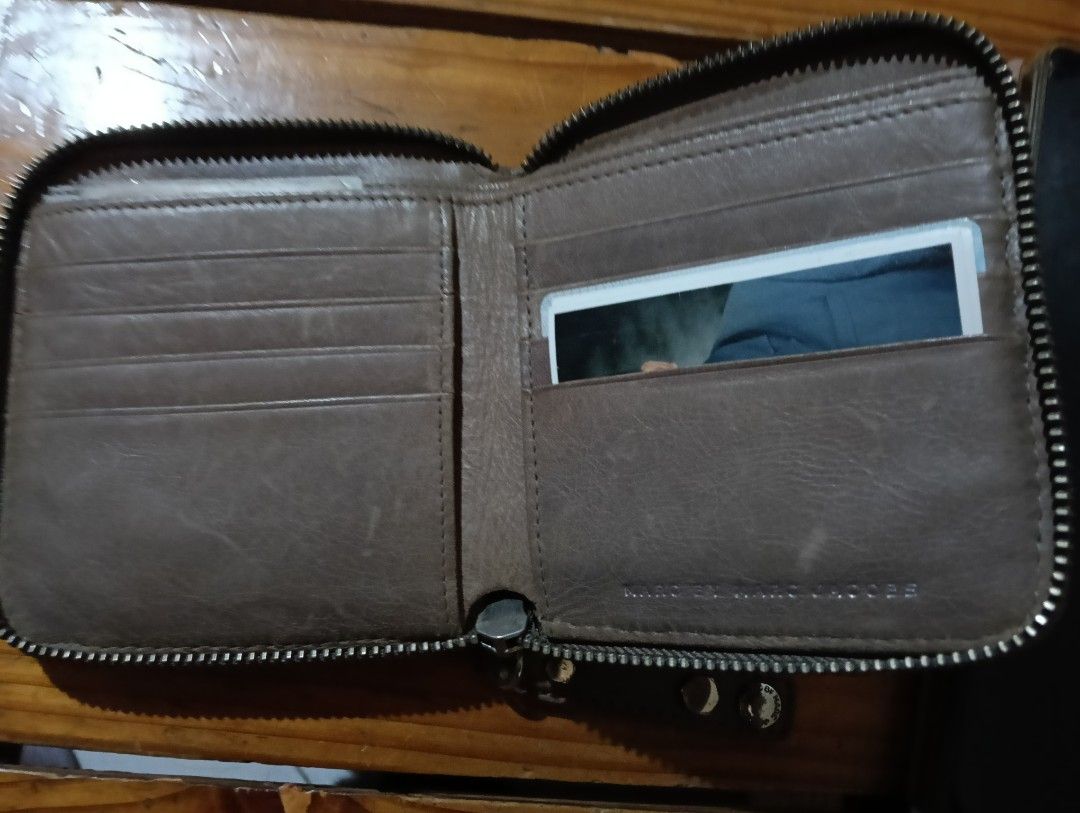 Marc by Marc Jacobs Standard Supply Workwear Zip Wallet (Category: Wallets & Card holders) located in Manila. Submitted by rakelherms (Listing ID 1468401858, Image 3). Description: - Authentic Marc by Marc Jacobs zip wallet in dark grey leather - Features iconic Standard Supply Workwear metal plaque on the front - Secure wraparound zip closure with matching leather pull - Multiple interior card slots and compartments for organization - Compact si
