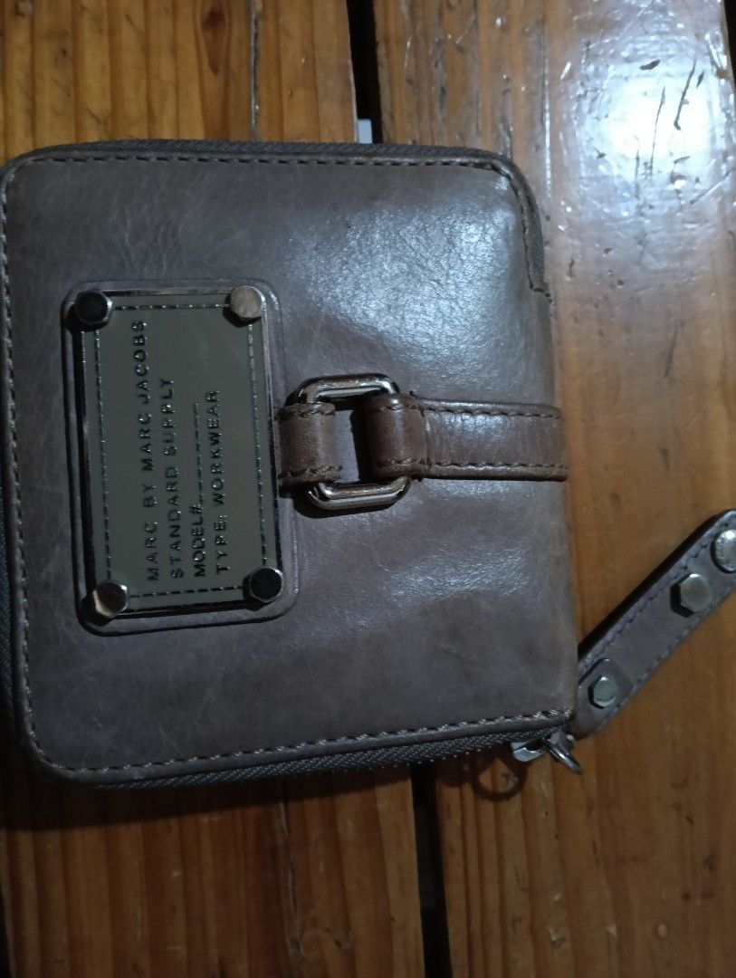 Marc by Marc Jacobs Standard Supply Workwear Zip Wallet (Category: Wallets & Card holders) located in Manila. Submitted by rakelherms (Listing ID 1468401858, Image 1). Description: - Authentic Marc by Marc Jacobs zip wallet in dark grey leather - Features iconic Standard Supply Workwear metal plaque on the front - Secure wraparound zip closure with matching leather pull - Multiple interior card slots and compartments for organization - Compact si