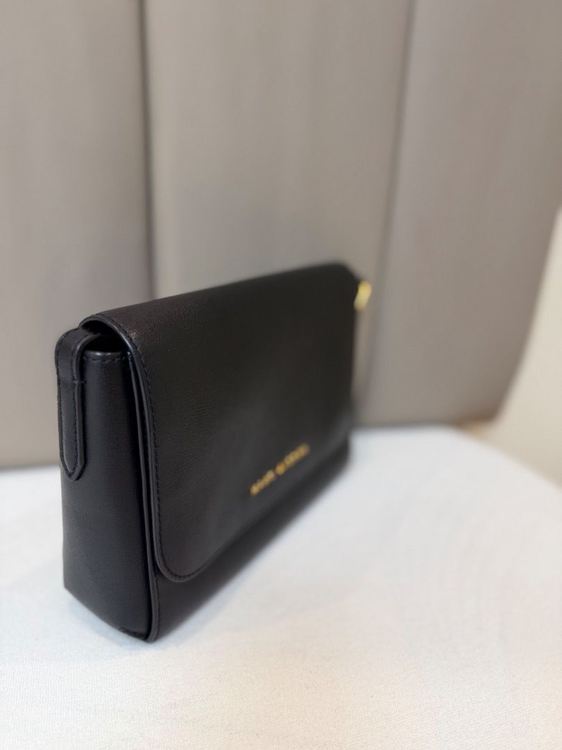 Marc Jacobs Black Leather Crossbody Bag (Category: Cross-body Bags) located in Rizal. Submitted by je_resada (Listing ID 1468434307, Image 2). Description: - Authentic Marc Jacobs crossbody bag - Crafted from durable black textured leather - Elegant gold foil logo on the front flap - Secure magnetic closure - Slim shoulder strap with polished gold-tone hardware - Structured, compact size ideal for daily essentials - Versatile minimalist design ma