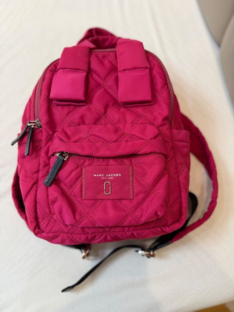 Marc Jacobs Quilted Nylon Backpack Hot Pink (Category: Backpacks) located in Rizal. Submitted by je_resada (Listing ID 1468433625, Image 3). Description: - Brand: Marc Jacobs - Color: Vibrant Hot Pink - Material: Durable quilted nylon with silver-tone hardware - Storage: Double zip main compartment and handy front zipped pocket - Straps: Top grab handles and adjustable black webbed shoulder straps - Condition: Brand new / Excellent - Perfect for 