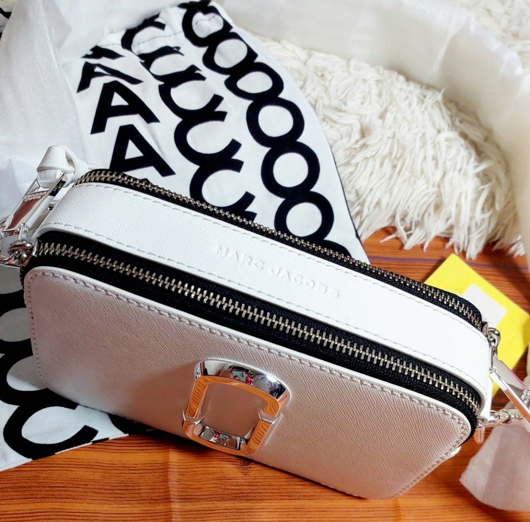 Marc Jacobs Snapshot Crossbody Bag White (Category: Luxury Bags & Wallets) located in Caloocan City. Submitted by clairyyyyy (Listing ID 1468453589, Image 1). Description: - Brand: Marc Jacobs - Style: Snapshot Camera Bag - Color: White with silver hardware - Material: Durable Saffiano leather - Condition: Brand new, never used, pristine condition - Features: Double zip closure and iconic 'J' logo - Inclusions: Dust bag, tag, and strap wrapped in