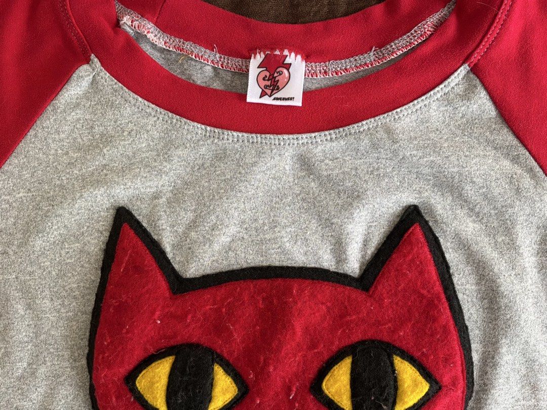 Marceline Adventure Time Red and Grey Cat Face Patch Raglan Crop Top (Category: Shirts) located in Dumaguete. Submitted by _l1lyy_ (Listing ID 1468339189, Image 3). Description: - Fit: S-M - Style: Short sleeve raglan crop top - Colors: Heather grey with vibrant red - Design: Large red cat patch with yellow/black felt eyes - Fit: Cropped length, ideal for high-waisted jeans or skirts - Material: Soft, comfortable cotton blend - Details: Features 