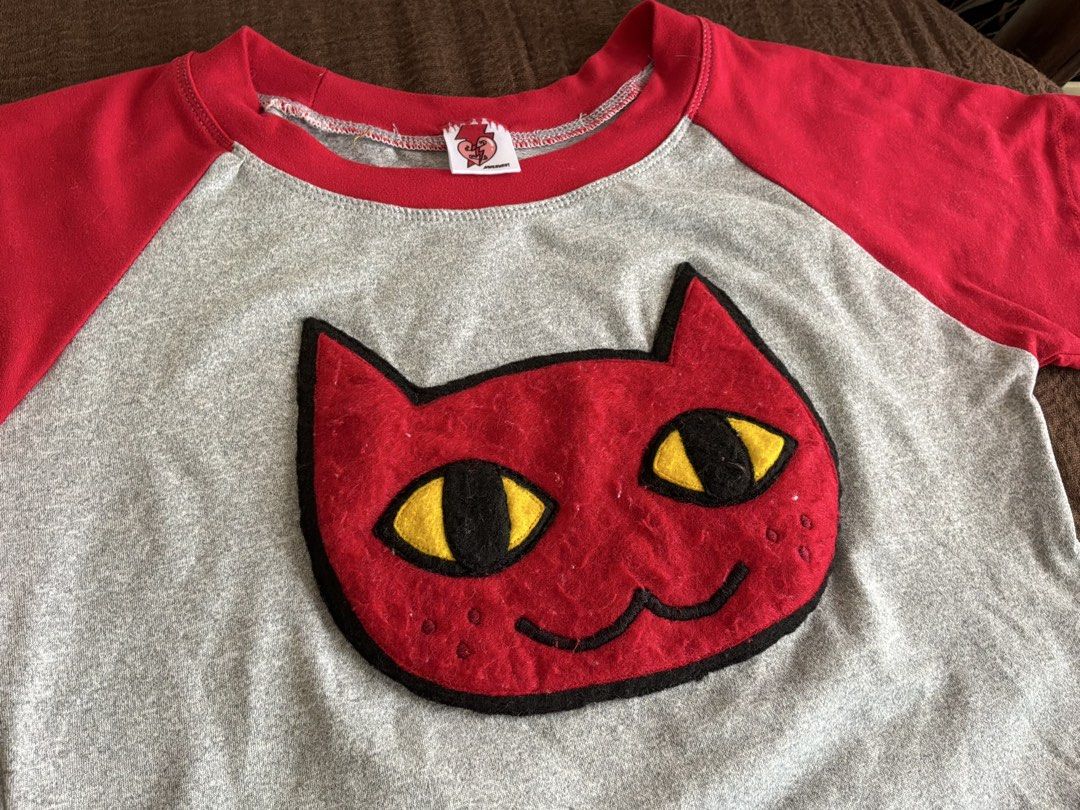 Marceline Adventure Time Red and Grey Cat Face Patch Raglan Crop Top (Category: Shirts) located in Dumaguete. Submitted by _l1lyy_ (Listing ID 1468339189, Image 2). Description: - Fit: S-M - Style: Short sleeve raglan crop top - Colors: Heather grey with vibrant red - Design: Large red cat patch with yellow/black felt eyes - Fit: Cropped length, ideal for high-waisted jeans or skirts - Material: Soft, comfortable cotton blend - Details: Features 