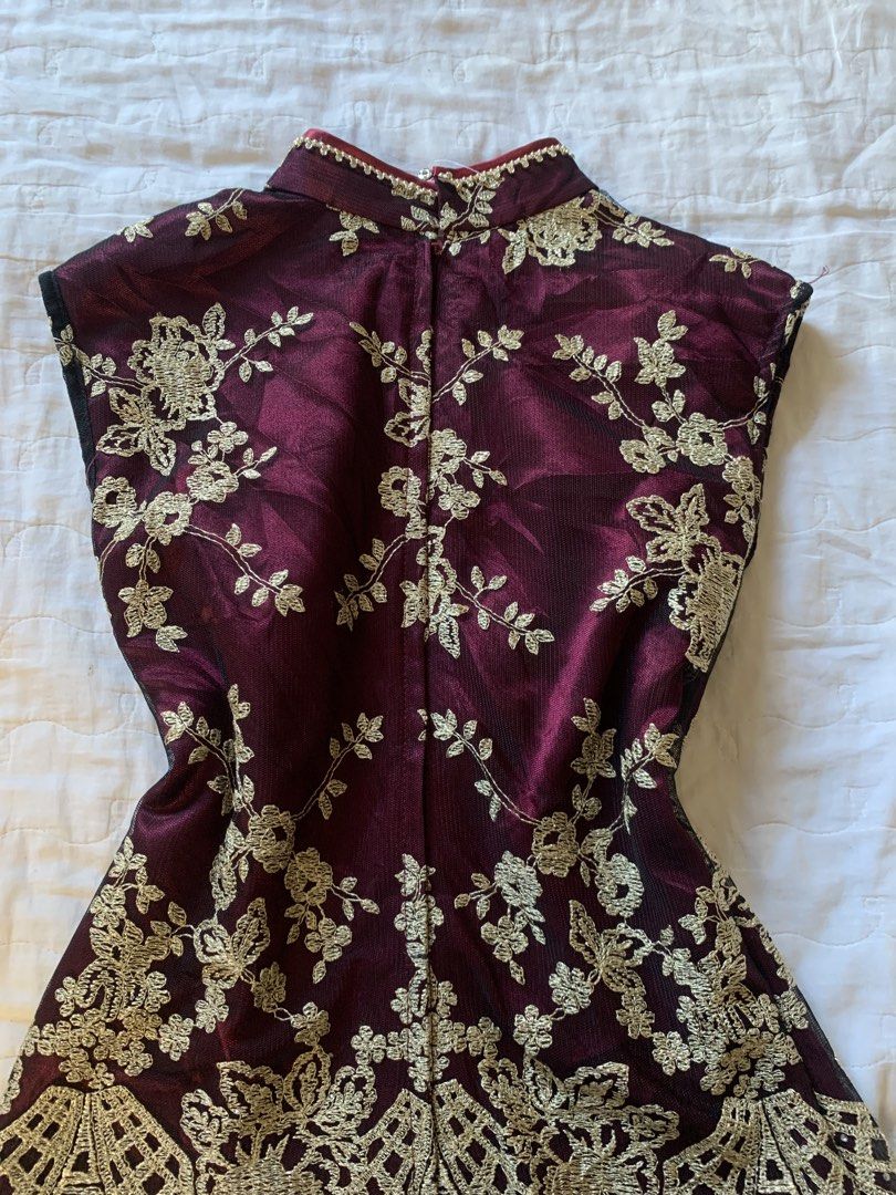 Maroon and Gold Embroidered Mandarin Collar Top (Category: Blouses) located in Sarangani. Submitted by solune_clo (Listing ID 1468404643, Image 3). Description: - Color: Deep maroon with gold floral embroidery - Design: Mandarin collar with beaded trim, front clasp closure, and sheer mesh panels - Fit: Fitted silhouette with a stylish flared lace hem - Sleeves: Short cap sleeves - Closure: Convenient back zip closure - Condition: Excellent pre-lo