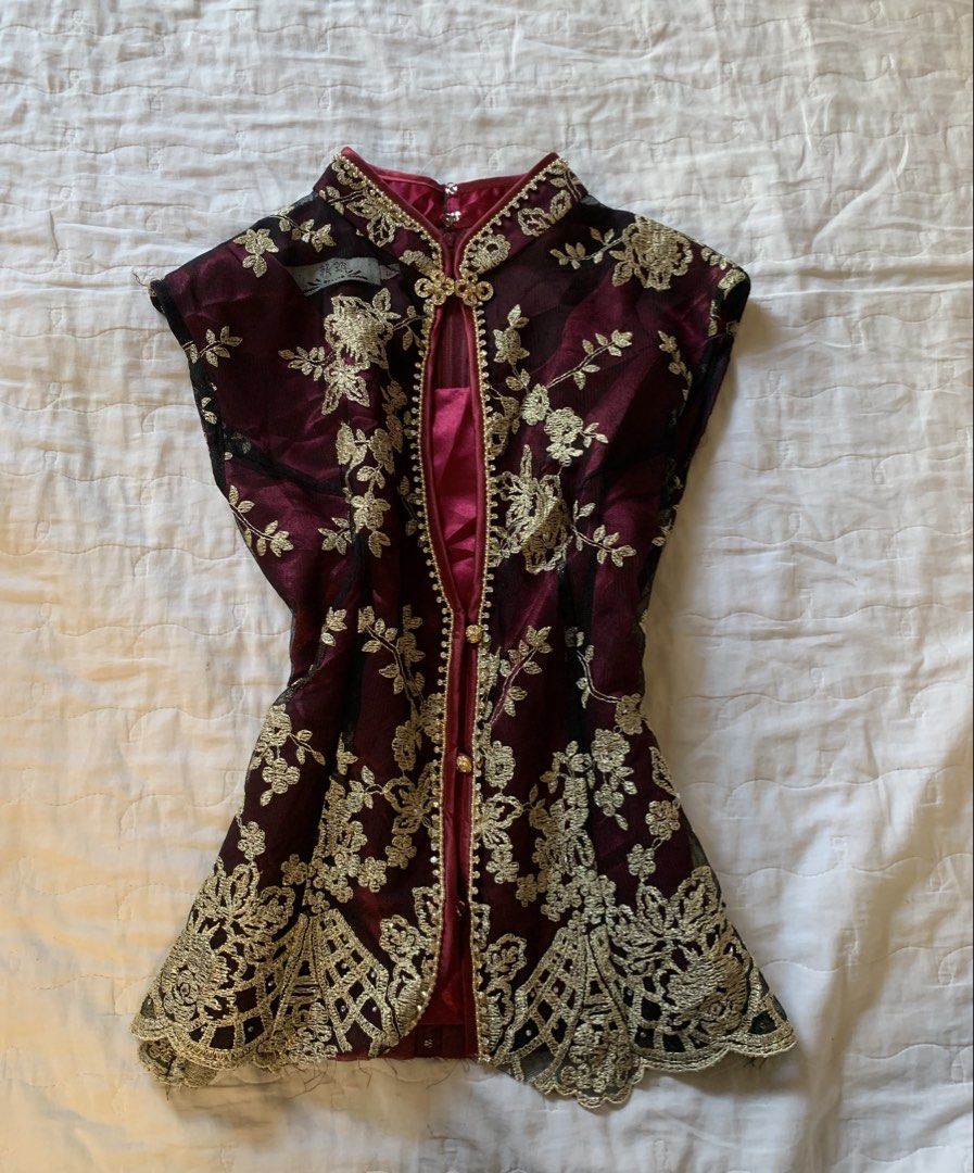 Maroon and Gold Embroidered Mandarin Collar Top (Category: Blouses) located in Sarangani. Submitted by solune_clo (Listing ID 1468404643, Image 1). Description: - Color: Deep maroon with gold floral embroidery - Design: Mandarin collar with beaded trim, front clasp closure, and sheer mesh panels - Fit: Fitted silhouette with a stylish flared lace hem - Sleeves: Short cap sleeves - Closure: Convenient back zip closure - Condition: Excellent pre-lo