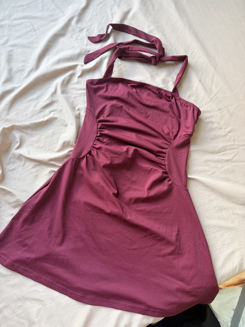 Maroon Halter Neck Dress with Ruched Sides (Category: Dresses) located in Manila. Submitted by lucipurrpreloved (Listing ID 1468341045, Image 2). Description: - Color: Maroon - Style: Halter mini dress with adjustable tie-back - Fit: Flattering ruched side panels with soft, stretchy fabric - Condition: Worn once, still in great shape.
