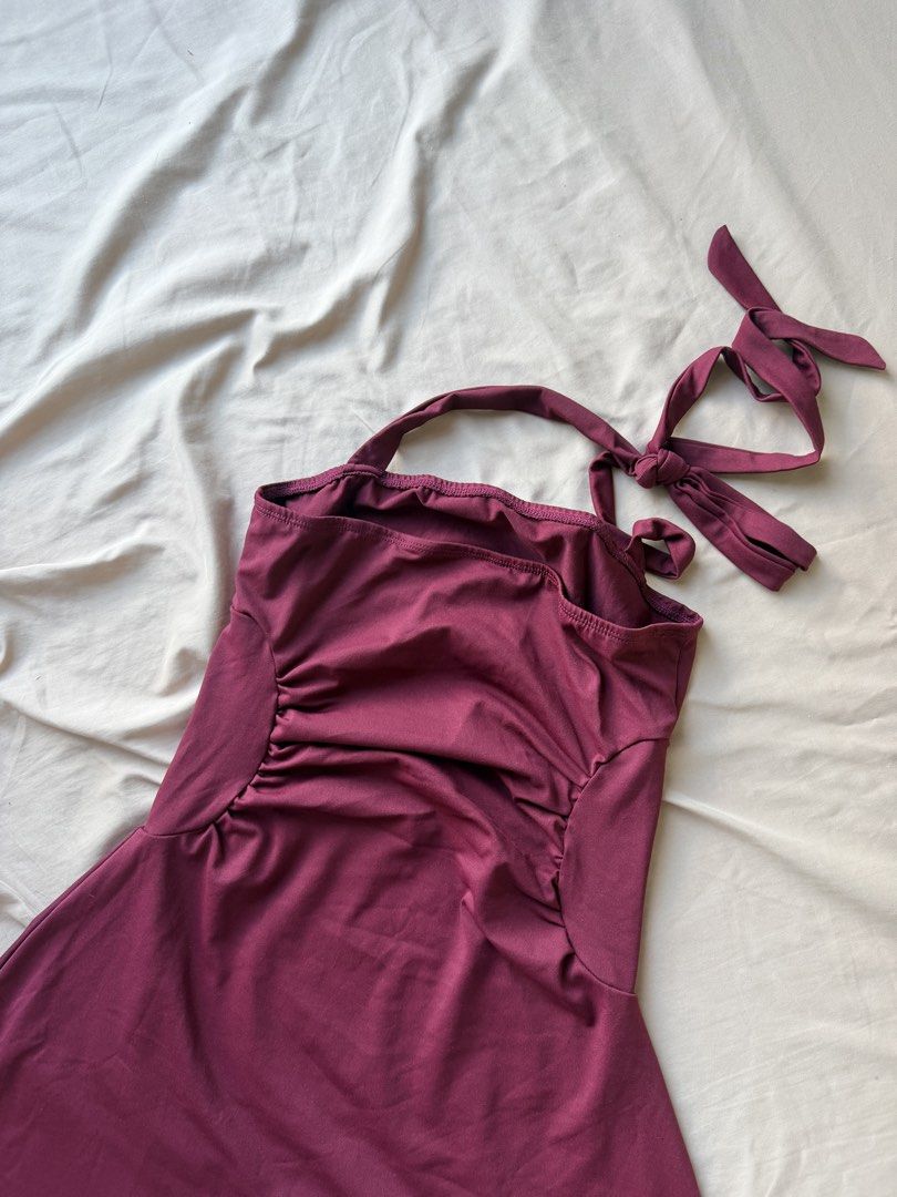 Maroon Halter Neck Dress with Ruched Sides (Category: Dresses) located in Manila. Submitted by lucipurrpreloved (Listing ID 1468341045, Image 3). Description: - Color: Maroon - Style: Halter mini dress with adjustable tie-back - Fit: Flattering ruched side panels with soft, stretchy fabric - Condition: Worn once, still in great shape.