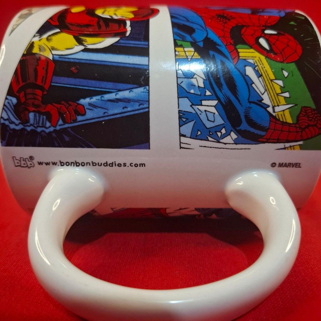 Marvel Comics Superhero Ceramic Coffee Mug Spider-Man Iron Man (Category: Coffee & Tea Tableware) located in Mandaluyong City. Submitted by edward123_andren (Listing ID 1468464862, Image 3). Description: - Official Bon Bon Buddies Marvel merchandise - Features iconic wraparound comic panels with Spider-Man, Iron Man, and Captain America - Bold Marvel Comics logo design - Clean white handle and interior - Standard mug size (approx. 10cm tall) - Gr