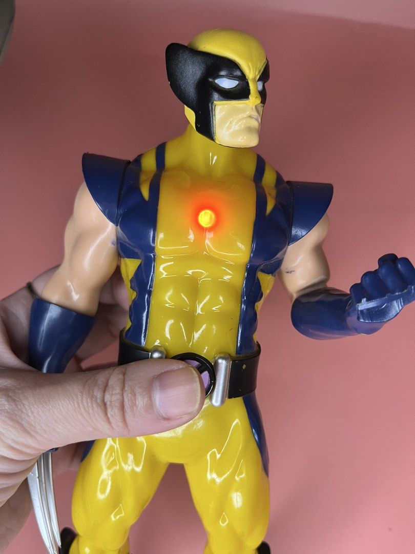 Marvel X-Men Wolverine electronic light-up action figure (Category: Figurines & Statues) located in Caloocan City. Submitted by snapshop_ph (Listing ID 1468403287, Image 3). Description: - Character: Wolverine in iconic blue and yellow costume - Features: Working red light-up chest feature (activated by chest button) and signature claws on one hand - Build: Classic screw assembly on limbs and torso with speaker holes on the back - Condition: Pre-