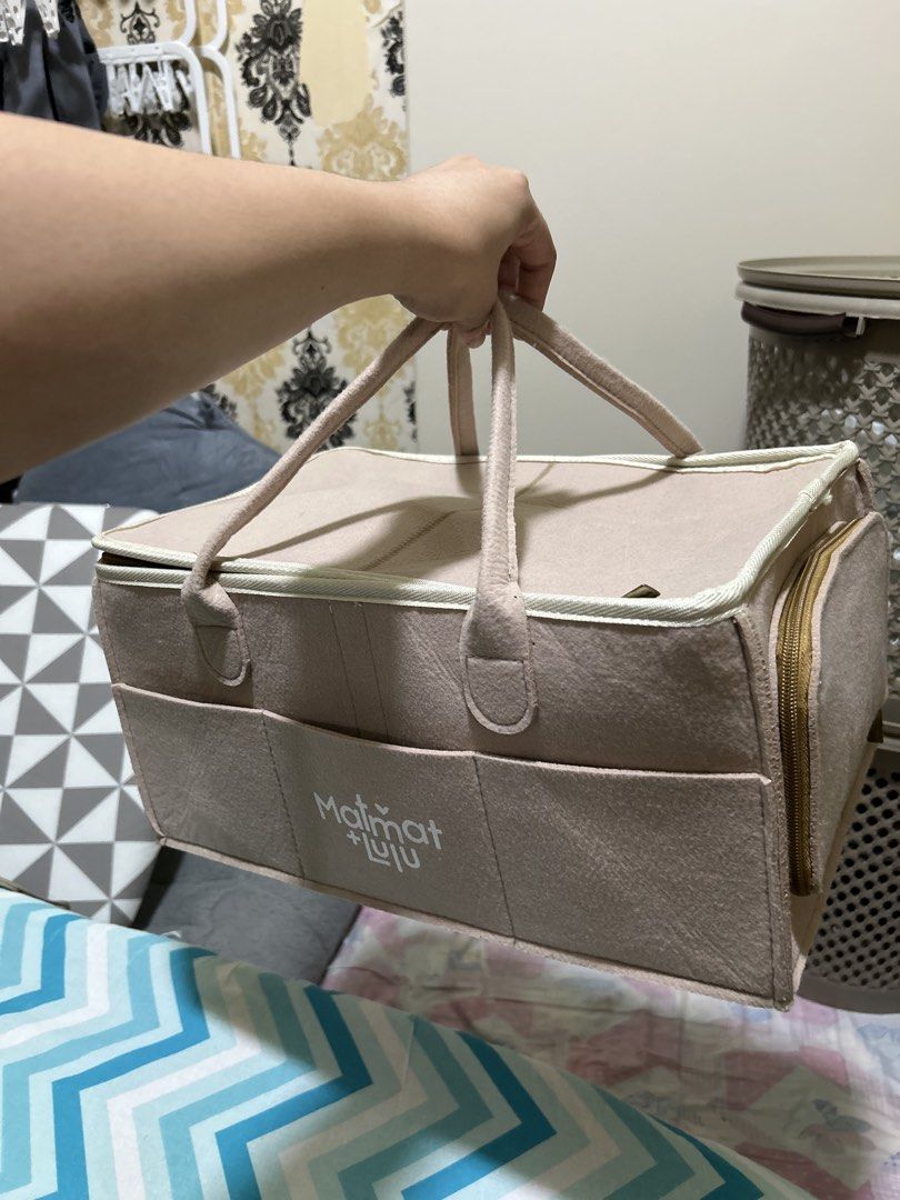 Matmat + Luju Felt Storage Caddy Organizer (Category: Storage Boxes & Baskets) located in Batangas. Submitted by chubyyyyy (Listing ID 1468385536, Image 2). Description: - Brand: Matmat + Luju - Color: Beige - Material: Sturdy felt with smooth interior lining - Features: Zipped top lid, sturdy carry handles, multiple exterior front pockets, and removable interior dividers for customizable compartments - Condition: Clean inside and out, excellent 