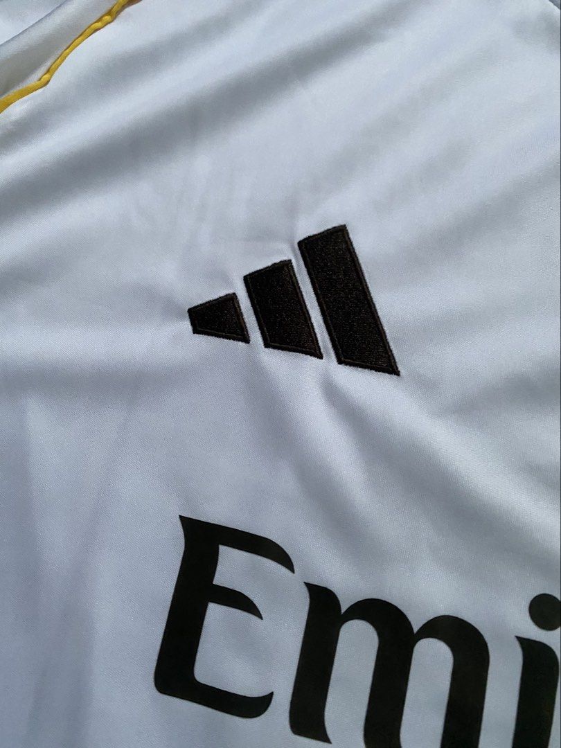 Mbappé Jersey (Category: Activewear) located in Abucay. Submitted by lili_pretty (Listing ID 1468420899, Image 2). Description: - Brand: Adidas - Player/Team: Mbappé (Real Madrid home jersey style) - Size: 2XL (Slim Fit) - Color: White with black accents - Condition: Brand new with tags - Features: Embroidered logo, high-quality fabric .