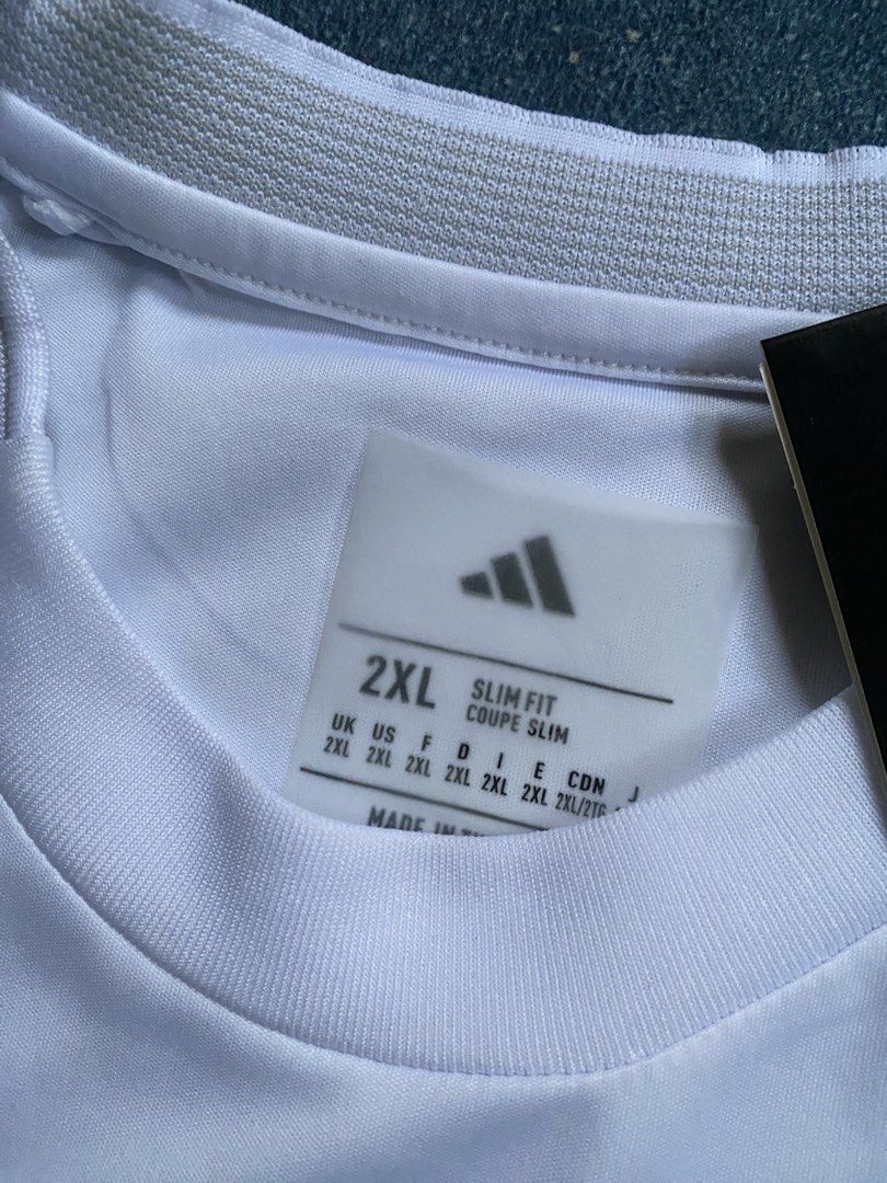 Mbappé Jersey (Category: Activewear) located in Abucay. Submitted by lili_pretty (Listing ID 1468420899, Image 3). Description: - Brand: Adidas - Player/Team: Mbappé (Real Madrid home jersey style) - Size: 2XL (Slim Fit) - Color: White with black accents - Condition: Brand new with tags - Features: Embroidered logo, high-quality fabric .
