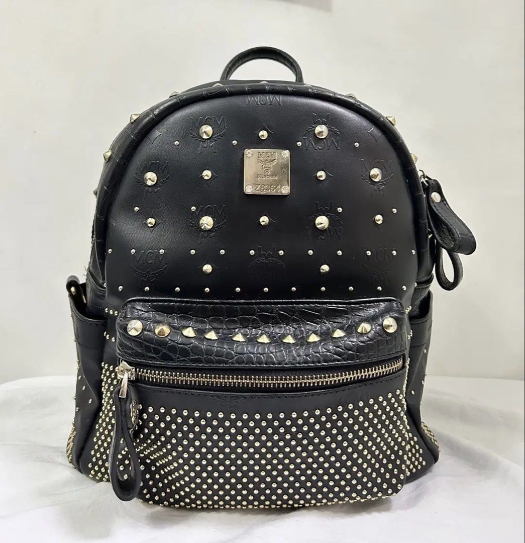 MCM LEATHER BLACK STUDDED BACKPACK (Category: Backpacks) located in Pasig City. Submitted by fruitselling (Listing ID 1468387074, Image 1). Description: ☁️ Size Medium ☁️Gold hardware ☁️ W/ minimal signs of used no major flaws. ☁️ Both zipper working.