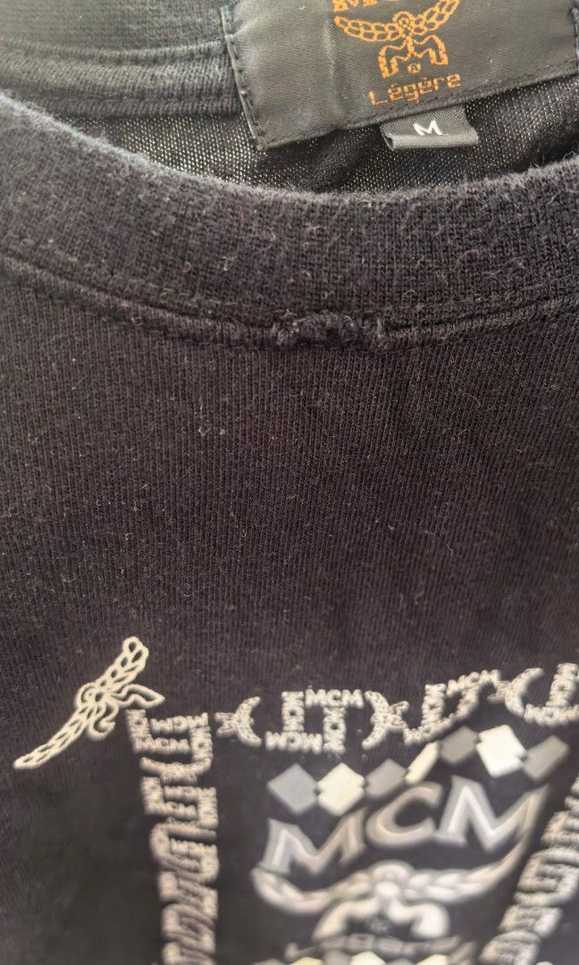 Mcm Shirt black medium size (Category: Activewear) located in Tuguegarao City. Submitted by zenphoenix-7ad615 (Listing ID 1468345526, Image 3). Description: Please see pictures of the flaw Sa neckline.