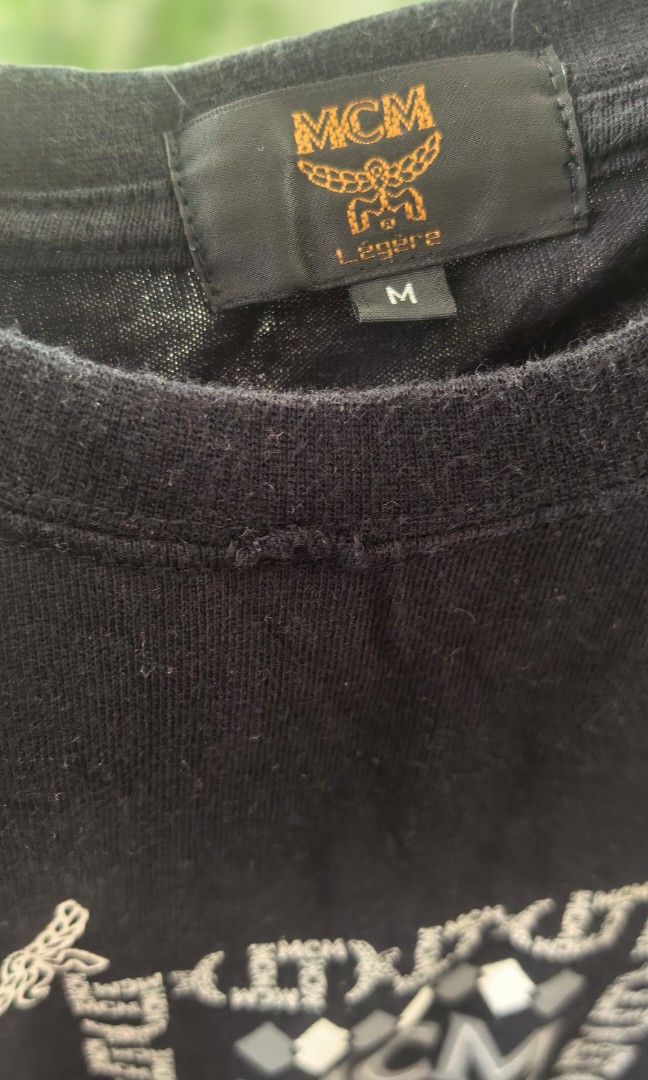 Mcm Shirt black medium size (Category: Activewear) located in Tuguegarao City. Submitted by zenphoenix-7ad615 (Listing ID 1468345526, Image 2). Description: Please see pictures of the flaw Sa neckline.