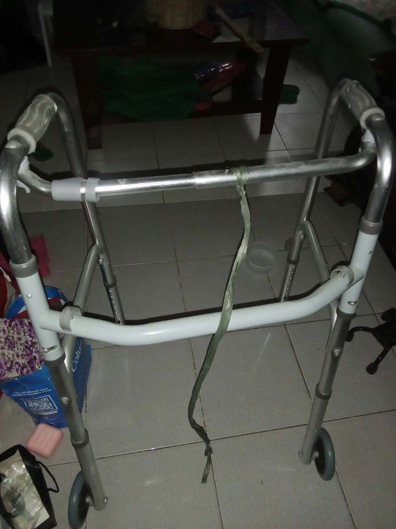 Medical walking frame with front wheels and adjustable height (Category: Medical Supplies & Tools) located in Manila. Submitted by chicoko.26 (Listing ID 1468459170, Image 1). Description: - Sturdy and lightweight metal frame in silver and grey - Smooth front wheels for easy movement - Adjustable height legs with push-button pins - Comfortable rubber hand grips - Front crossbar for enhanced stability - Folds easily for convenient storage and tran