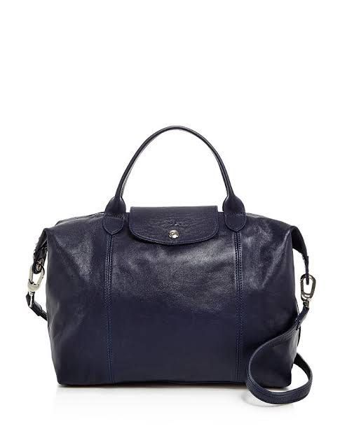 Medium Leather Longchamp Cuir (Category: Luxury Bags & Wallets) located in Quezon City. Submitted by PrelovedTreasureees (Listing ID 1468336871, Image 1). Description: - Genuine leather - Has a few marks on it from usage (pls refer to pics) - Lining of the inner zipped pocket has stains on it - Comes with a dust bag and detachable strap - Foldable.