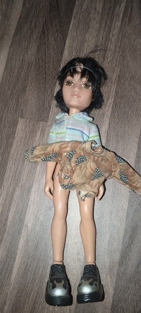 MGA Bratz Boyz Dylan Doll with Extra Outfit (Category: Kids Toys) located in Manila. Submitted by sulli_24 (Listing ID 1468283582, Image 1). Description: - Character: Bratz Boyz Dylan - Features: Short black hair, brown eyes, and articulated body - Outfit: Striped short-sleeve shirt and black flame boots - Extras: Includes an additional brown patterned jacket - Condition: Clean, great overall display piece - Ideal for: Fashion doll collections.