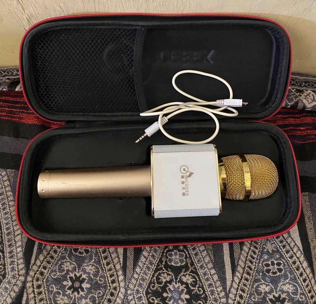 MicGeek Wireless Karaoke Microphone with Case (Category: Microphones) located in Baguio. Submitted by thrift_bonita (Listing ID 1468344012, Image 2). Description: - Brand: MicGeek Wireless Karaoke Microphone - Color: Elegant Gold and White - Connectivity: Bluetooth compatible with Android and iOS - Sound Controls: Front sliders for volume, bass, treble, and reverb - Condition: Clean, powers on, and ready for use - Inclusions: Charging cable and d