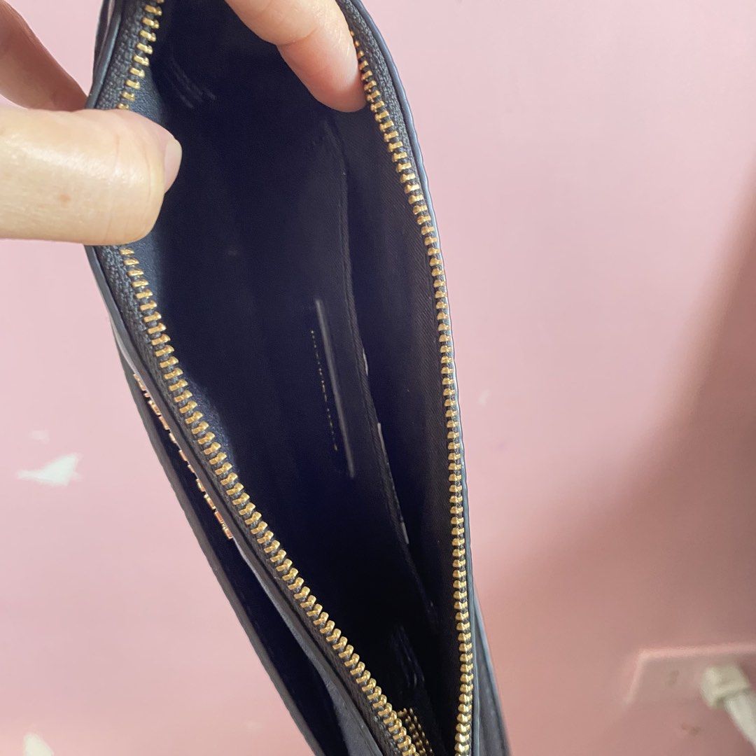 Michael Kors Black Leather Wristlet Pouch (Category: Luxury Bags & Wallets) located in Imus. Submitted by wheagirl (Listing ID 1468284315, Image 2). Description: - Brand: Michael Kors - Material: Black pebbled leather with gold hardware - Closure: Secure top zip closure - Interior: Fabric-lined with built-in card slots and a slip pocket - Convenience: Includes an attached side wrist strap - Condition: Great for quick errands, holds cash and cards