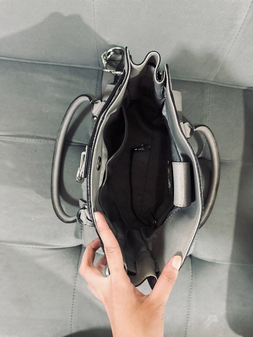 Michael Kors Gray Studded Satchel Handbag (Category: Luxury Bags & Wallets) located in Tarlac. Submitted by via_banana (Listing ID 1468352049, Image 2). Description: - Brand: Michael Kors - Material: Durable gray Saffiano leather - Hardware: Silver-tone with chic padlock accent and side chain links - Compartments: Center zip divider with multiple interior slip and zip pockets - Straps: Double top handles and an adjustable/removable shoulder strap
