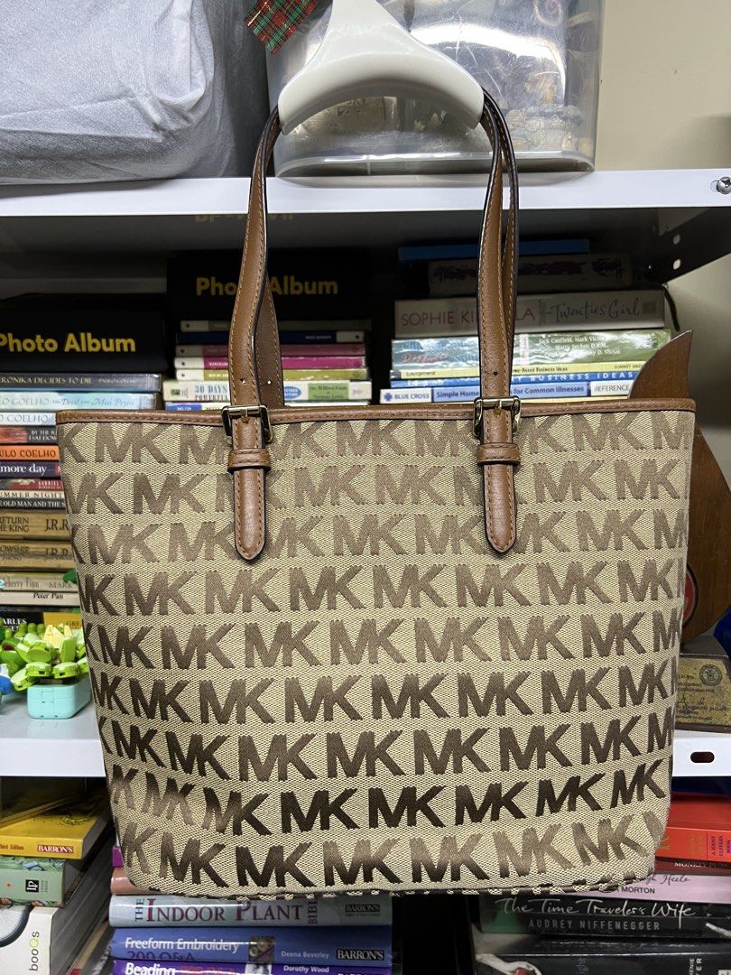 Michael Kors Monogram Tote Bag Brown Beige (Category: Luxury Bags & Wallets) located in Manila. Submitted by apoltree (Listing ID 1468446122, Image 3). Description: - Brand: Michael Kors - Material: Classic beige canvas with brown leather trim - Design: Iconic MK monogram print all over with gold-tone hardware - Features: Adjustable buckle straps, front slip pocket with button snap closure - Interior: Spacious main compartment, perfect for everyd