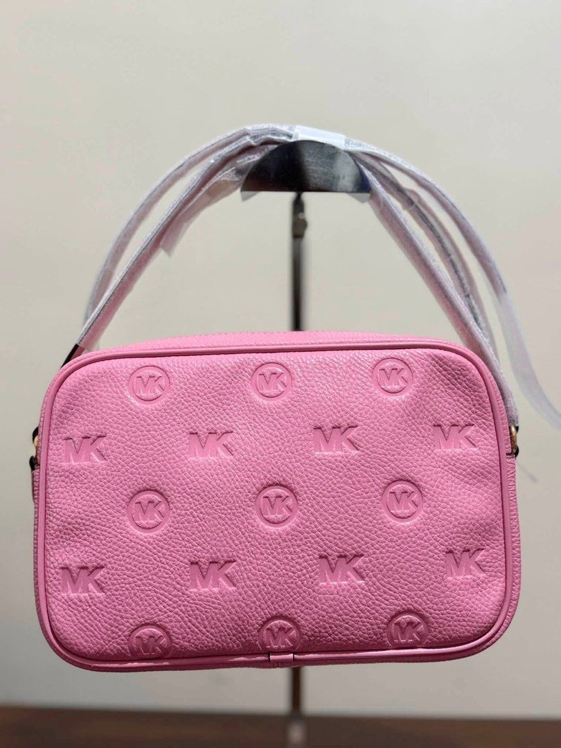 Michael Kors Pink Embossed MK Logo Crossbody Bag (Category: Cross-body Bags) located in Batangas. Submitted by theprelovedfinds (Listing ID 1468356389, Image 2). Description: - Brand: Michael Kors - Color: Bright Pink - Material: Leather with embossed MK logo - Hardware: Gold-tone - Interior: MK signature fabric lining with slip pocket and leather brand tag - Strap: Adjustable (wrapped in protective paper) - Condition: Brand new with original sto