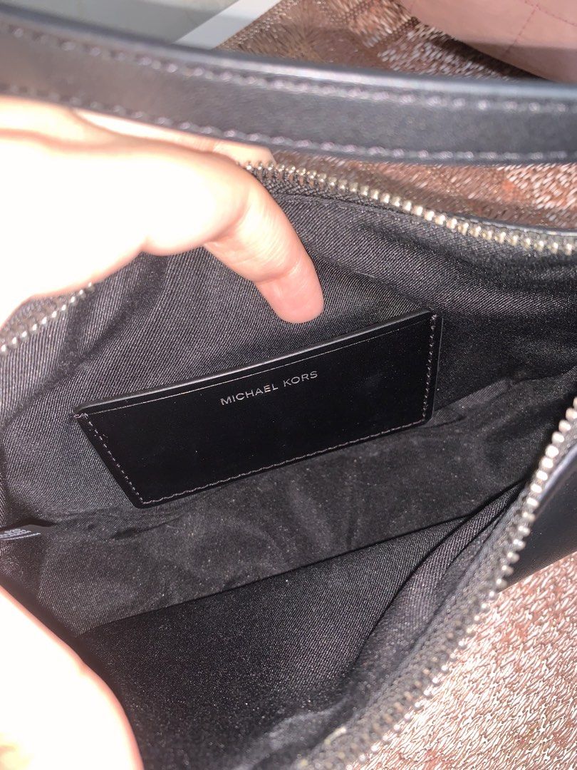 Michael Kors Small Convertible Pochette Black (Category: Luxury Bags & Wallets) located in Makati City. Submitted by FashionFactory (Listing ID 1468369478, Image 3). Description: - Authentic Michael Kors black leather shoulder bag - Sleek silver hardware with front MK logo lettering - Versatile 2-in-1 design: converts from a short pochette to a crossbody using detachable straps - Interior pocket features official Michael Kors branding label - Com