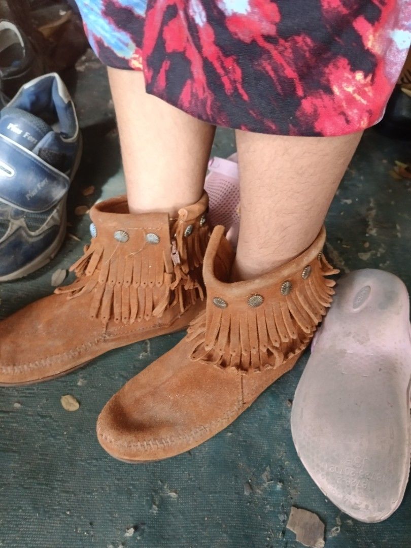 Minnetonka Fringe Suede Boots Brown (Category: Boots) located in Valenzuela. Submitted by relchris22 (Listing ID 1468360613, Image 1). Description: - Brand: Minnetonka - Material: Soft brown suede upper with durable rubber sole - Design: Moccasin-style toe stitching, ankle fringe, braided trim, and metal concho studs - Closure: Convenient side zipper for easy slip-on - Comfort: Perfect and cozy for everyday wear.