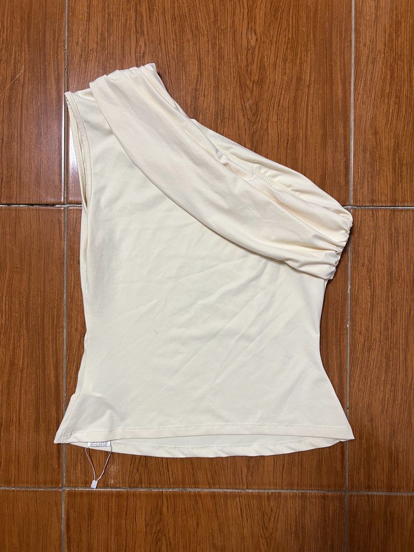 Missguided One Shoulder Cream Top Size M (Category: Sleeveless) located in Quezon City. Submitted by declutterwithrei (Listing ID 1468449905, Image 1). Description: Missguided cream one-shoulder top in size medium. Features a smooth, stretchy fabric and chic asymmetric draped front. Perfect for pairing with jeans or trousers for a classy look..