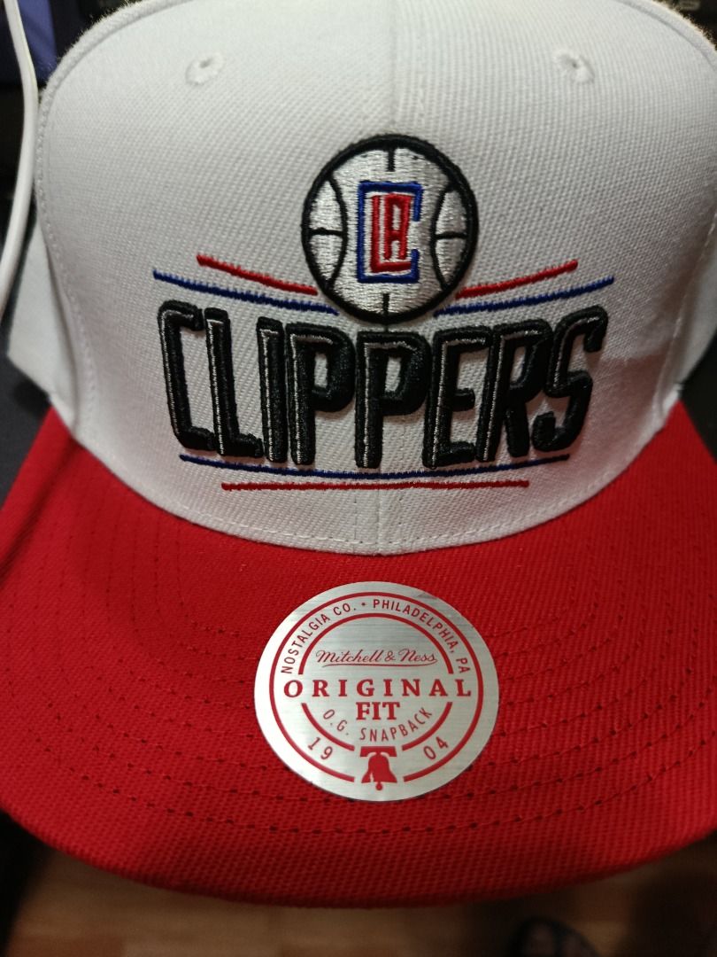 Mitchell & Ness LA Clippers NBA Snapback Hat White Red (Category: Caps & Hats) located in Pasig City. Submitted by gutierrez.gardo (Listing ID 1468295709, Image 1). Description: - Brand: Mitchell & Ness - Team: Los Angeles Clippers - Colorway: White crown with striking red top button, eyelets, strap, and underbrim - Authenticity: Includes official NBA hologram sticker and original store retail tag - Fit: Structured fit with branded interior tapin
