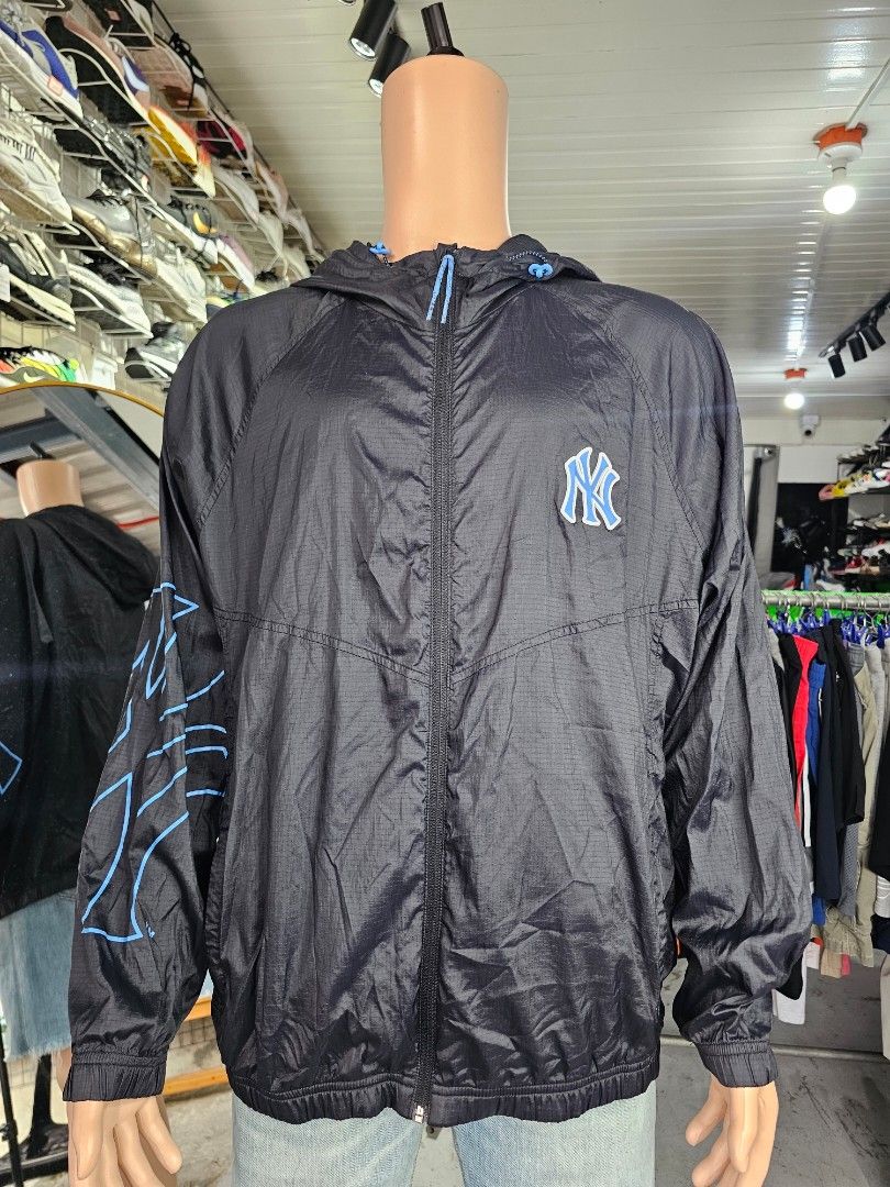 MLB New York Yankees black windbreaker jacket (Category: Coats, Jackets and Outerwear) located in Baguio. Submitted by kayeonlineshop (Listing ID 1468325746, Image 2). Description: -MLB New York Yankees black windbreaker jacket featuring a full-zip closure, an attached hood with blue drawstrings, and blue team branding including the NY logo on the chest and graphic detailing on the sleeve.