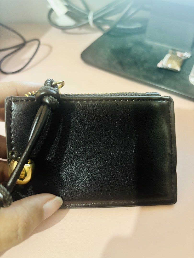 MNG Black Small Wallet Purse (Category: Wallets & Card holders) located in Cavite. Submitted by gianflores (Listing ID 1468471600, Image 3). Description: - Brand: MNG - Color: Classic Black with elegant gold hardware - Closure: Secure snap closure - Compartments: Top zippered pocket with a stylish knotted pull string - Size: Compact, fits easily in small bags and pockets - Condition: Clean interior and exterior, well-maintained.